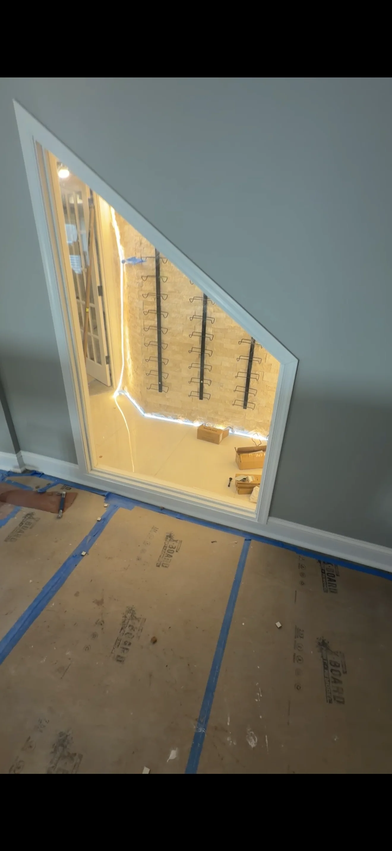 Custom angled frameless mirror with LED edge lighting installed by Pyramid Glass LLC